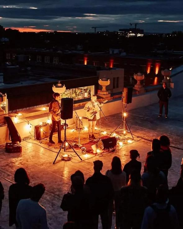 A rooftop set at dusk